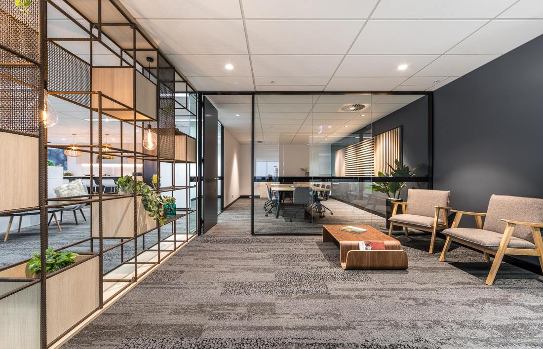 Perth office fitout by Hub Interiors with a reception waiting area, mesh and timber screen and a glazed meeting room